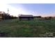 View of a sturdy barn set in a spacious yard, ideal for storage or agricultural pursuits at 1524 J Rhyne Reep Rd, Vale, NC 28168