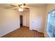 A bright bedroom features a ceiling fan, wood floors, and a built-in closet at 1524 J Rhyne Reep Rd, Vale, NC 28168