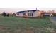 A charming one-story home with a well-kept lawn, wooden porch, and a utility shed on the property at 1524 J Rhyne Reep Rd, Vale, NC 28168