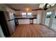 Kitchen featuring white cabinets, stainless steel appliances, and wood-look floors at 1524 J Rhyne Reep Rd, Vale, NC 28168