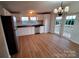 Kitchen featuring stainless steel appliances, ample white cabinetry, and wood-look flooring at 1524 J Rhyne Reep Rd, Vale, NC 28168