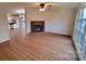 Bright and open living room featuring a decorative fireplace, ceiling fan, and wood-look flooring at 1524 J Rhyne Reep Rd, Vale, NC 28168