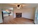 Open living room featuring a decorative brick fireplace, a ceiling fan, and wood-look flooring at 1524 J Rhyne Reep Rd, Vale, NC 28168