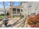Landscaped backyard boasts stone patio, stone grill, and screened-in porch, ideal for entertaining and outdoor enjoyment at 16123 Chiltern Ln, Huntersville, NC 28078