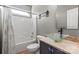 Bathroom featuring modern vanity with glass sink, tub, and a framed mirror at 16123 Chiltern Ln, Huntersville, NC 28078