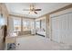 Large bedroom featuring a ceiling fan, carpeted floor, window seat, and a work desk for studying at 16123 Chiltern Ln, Huntersville, NC 28078