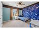 Charming bedroom with a unique blue map accent wall, ceiling fan, and natural light from the window at 16123 Chiltern Ln, Huntersville, NC 28078