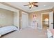 Bright bedroom features a ceiling fan, closet, and a connecting door to a hallway with a staircase at 16123 Chiltern Ln, Huntersville, NC 28078