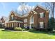 Charming brick two-story home with manicured lawn and beautiful landscaping at 16123 Chiltern Ln, Huntersville, NC 28078