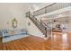 Elegant foyer featuring hardwood floors, a staircase with iron railings, and views into the living room at 16123 Chiltern Ln, Huntersville, NC 28078