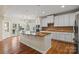 Open concept kitchen featuring an island, stainless appliances and adjacent dining area at 16123 Chiltern Ln, Huntersville, NC 28078