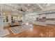 Open-concept living room featuring hardwood floors, a fireplace and a coffered ceiling at 16123 Chiltern Ln, Huntersville, NC 28078