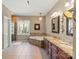 Main bathroom featuring double vanity with granite countertops, soaking tub, and a glass shower at 16123 Chiltern Ln, Huntersville, NC 28078