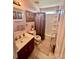 Cozy bathroom featuring a single sink vanity, tub/shower, and floral decorations at 16306 Hayfield Rd, Charlotte, NC 28213