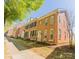 Attractive brick townhomes showcasing a clean design, black shutters, and a well-maintained lawn at 165 Singleton Rd, Mooresville, NC 28117