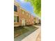 Beautiful brick townhome featuring classic black shutters and a tidy front garden, offering curb appeal at 165 Singleton Rd, Mooresville, NC 28117