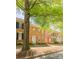 Charming brick townhome with black shutters and a welcoming front porch, shaded by a mature tree at 165 Singleton Rd, Mooresville, NC 28117