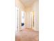 Bright hallway leading to bedrooms and a bathroom featuring neutral paint and plush carpeting throughout at 165 Singleton Rd, Mooresville, NC 28117