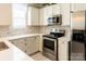 Updated kitchen featuring white cabinets, stainless steel appliances, and sleek countertops offers lots of space at 165 Singleton Rd, Mooresville, NC 28117
