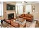 Cozy living room boasts a fireplace, mounted TV, two couches, and plenty of natural light at 165 Singleton Rd, Mooresville, NC 28117