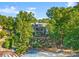 Aerial view of waterfront home with private beach, patio, and lush landscaping at 18420 Rosapenny Rd, Charlotte, NC 28278
