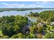 Stunning aerial view of waterfront property with lush landscaping and private dock on a sunny day at 18420 Rosapenny Rd, Charlotte, NC 28278