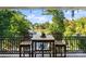 Inviting balcony with table and chairs provides stunning lake views and a serene outdoor space for relaxation and dining at 18420 Rosapenny Rd, Charlotte, NC 28278