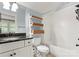 Well-lit bathroom with granite countertop, decorative ladder shelves, and shower with tub at 18420 Rosapenny Rd, Charlotte, NC 28278