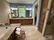 Luxurious bathroom featuring granite counters, a soaking tub, and a separate shower at 18420 Rosapenny Rd, Charlotte, NC 28278