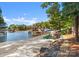 Private beach with lounge chairs, umbrellas, and lake access on a sunny day at 18420 Rosapenny Rd, Charlotte, NC 28278