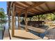 Covered boat slip featuring boat and wooden support beams and dock at 18420 Rosapenny Rd, Charlotte, NC 28278
