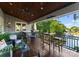 Relaxing covered porch with ample seating, a wooden ceiling, and scenic views of the lake and lush greenery at 18420 Rosapenny Rd, Charlotte, NC 28278