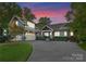 Charming two-story home with a well-manicured lawn, spacious driveway, and inviting entrance at 18420 Rosapenny Rd, Charlotte, NC 28278