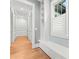 Bright hallway with hardwood flooring, custom millwork, and a built-in bookshelf at 18420 Rosapenny Rd, Charlotte, NC 28278