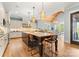 Spacious kitchen featuring an island with seating, stainless steel appliances, and a view into the dining area at 18420 Rosapenny Rd, Charlotte, NC 28278