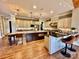 An open, bright kitchen features an island, bar seating, and modern appliances at 18420 Rosapenny Rd, Charlotte, NC 28278