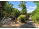 Backyard patio features a firepit area with Adirondack chairs, landscaping, and a walkway leading to the waterfront at 18420 Rosapenny Rd, Charlotte, NC 28278