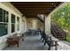 Stone patio features outdoor seating and an exterior staircase, offering an inviting space for outdoor entertaining and relaxation at 18420 Rosapenny Rd, Charlotte, NC 28278