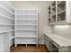 A walk-in pantry boasts custom shelving and a built-in desk area for organized storage at 18420 Rosapenny Rd, Charlotte, NC 28278