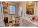 Bright bathroom with a white vanity, wood shelves and modern fixtures at 2114 Whitworth Rd, Cherryville, NC 28021