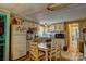 Eat-in kitchen with charming wood table, white cabinets, and stylish backsplash at 2114 Whitworth Rd, Cherryville, NC 28021