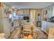 Bright eat-in kitchen with updated appliances, a farmhouse-style table, and ample cabinet space at 2114 Whitworth Rd, Cherryville, NC 28021