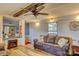 Cozy living room with a modern ceiling fan, gray walls and wood-look floors, perfect for relaxing at 2114 Whitworth Rd, Cherryville, NC 28021