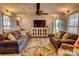 Spacious living room featuring matching sofas, a modern TV, and bright natural lighting at 2114 Whitworth Rd, Cherryville, NC 28021