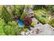 An aerial view shows the home, pool, patio and backyard with mature trees at 2120 Malvern Rd, Charlotte, NC 28207