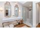 Bright bathroom featuring a glass shower, skylight and dual sinks with modern countertops at 2120 Malvern Rd, Charlotte, NC 28207