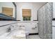 Vintage bathroom featuring a marble-topped sink and a black and white patterned shower curtain at 2120 Malvern Rd, Charlotte, NC 28207