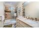 Well-lit bathroom with shower-tub, neutral tile accents, and vanity with stone countertop at 2120 Malvern Rd, Charlotte, NC 28207