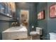 Powder room features an accent mirror, marble sink, and classic fixtures with views through to the kitchen at 2120 Malvern Rd, Charlotte, NC 28207