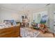 Bright room with large windows, neutral walls, hardwood floors, and room for an art studio at 2120 Malvern Rd, Charlotte, NC 28207